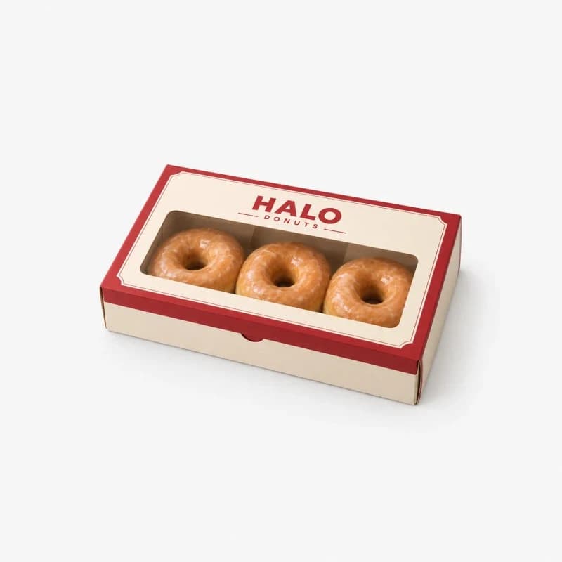 Red and cream window box holding three glazed donuts, brand Halo Donuts