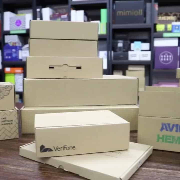 Stack of kraft corrugated mailer boxes in different sizes on a table